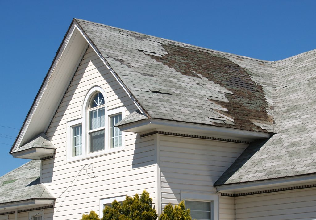 A grey roofing needing to be replaced due to damage